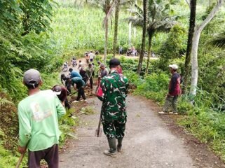 Foto: Babinsa Koramil 0806-04/Bendungan bersama warga melaksanakan karya bakti membersihkan material tanah longsor dan saluran air di Dusun Soko, Desa Depok, Kecamatan Bendungan, Kabupaten Trenggalek, Minggu (11/1/2026)
