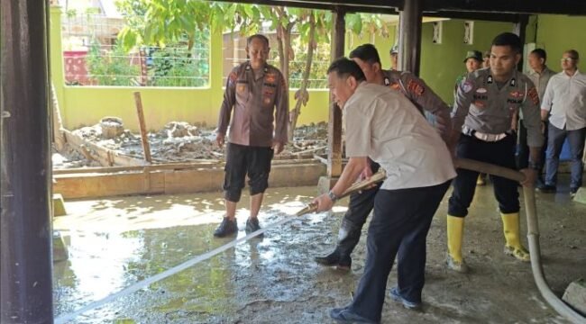KSP dan TNI-Polri bahu membahu membersihkan lumpur akibat benacana banjir bandang. (Foto: KSP)
