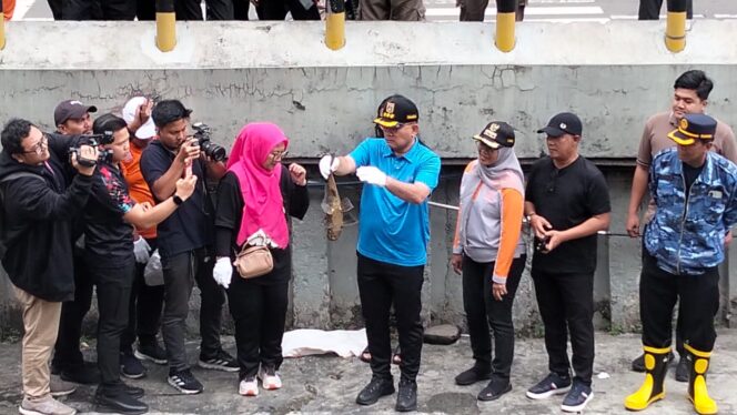 
					Wali Kota Jakarta Pusat, Arifin, menunjukkan ikan sapu-sapu hasil tangkapan saat memimpin kegiatan pengendalian spesies invasif di saluran air kawasan Plaza Indonesia, Jakarta, Jumat.